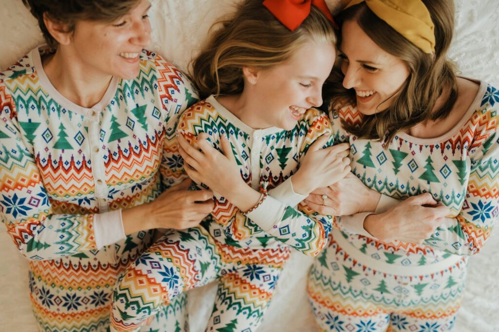 Family relaxing in matching Christmas pyjamas