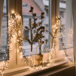 Window decorated with warm Christmas fairy lights