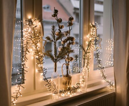 Window decorated with warm Christmas fairy lights