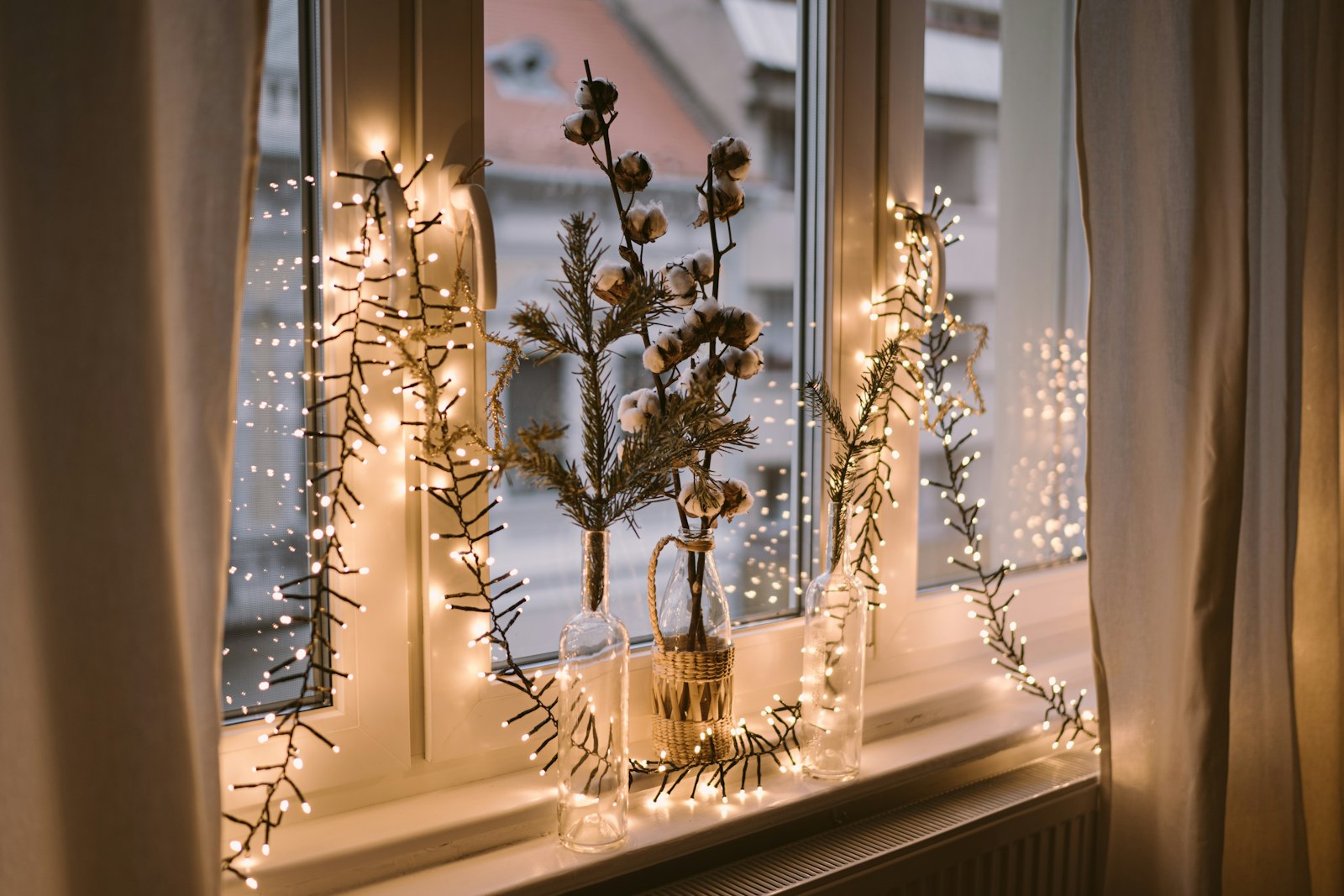 Window decorated with warm Christmas fairy lights